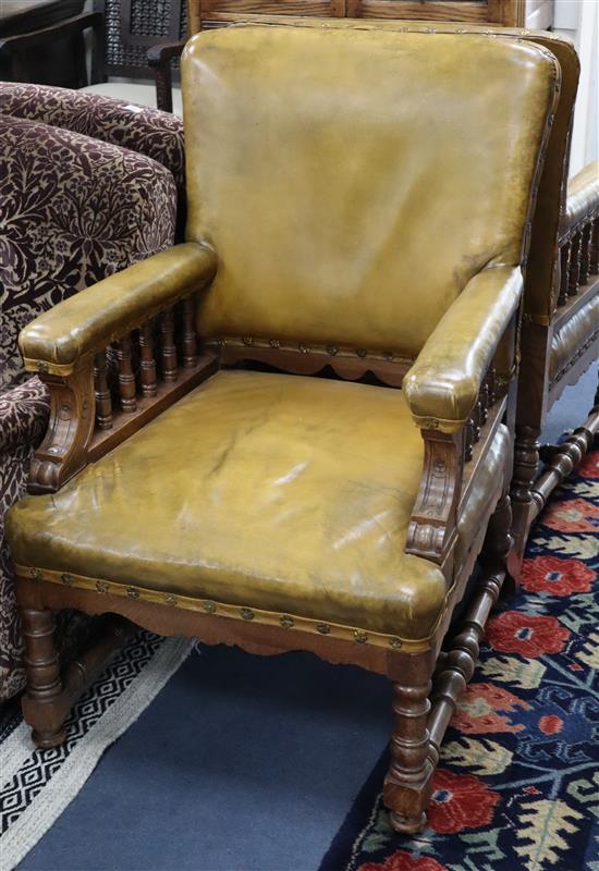 A pair of Victorian oak library chairs, upholstered in pale green leather, W.68cm D.76cm H.102cm